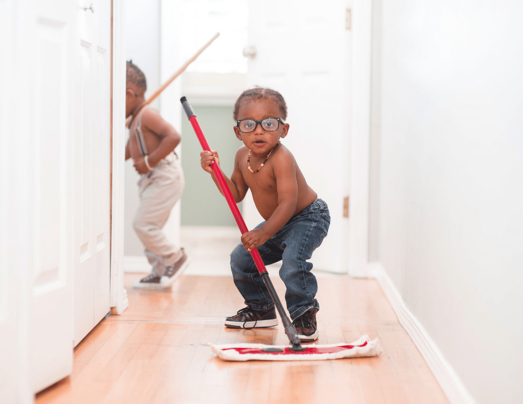 Funny kids with mop cleaning